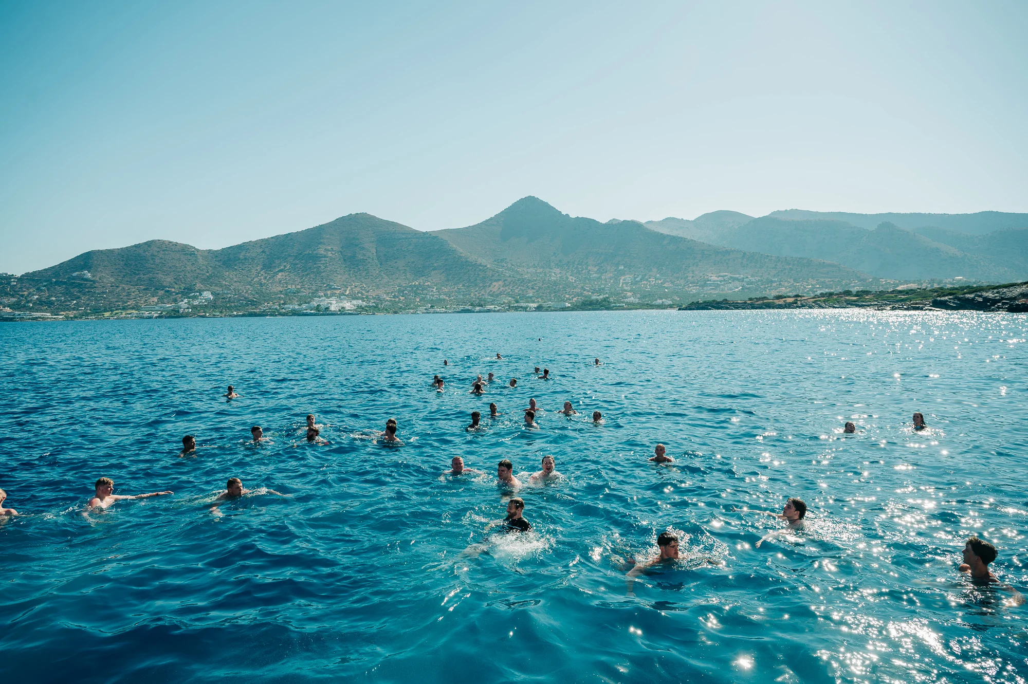 Swim stop on the Malia Booze Cruise – clear blue water, sun blazing and everyone cooling off before the party kicks back off.