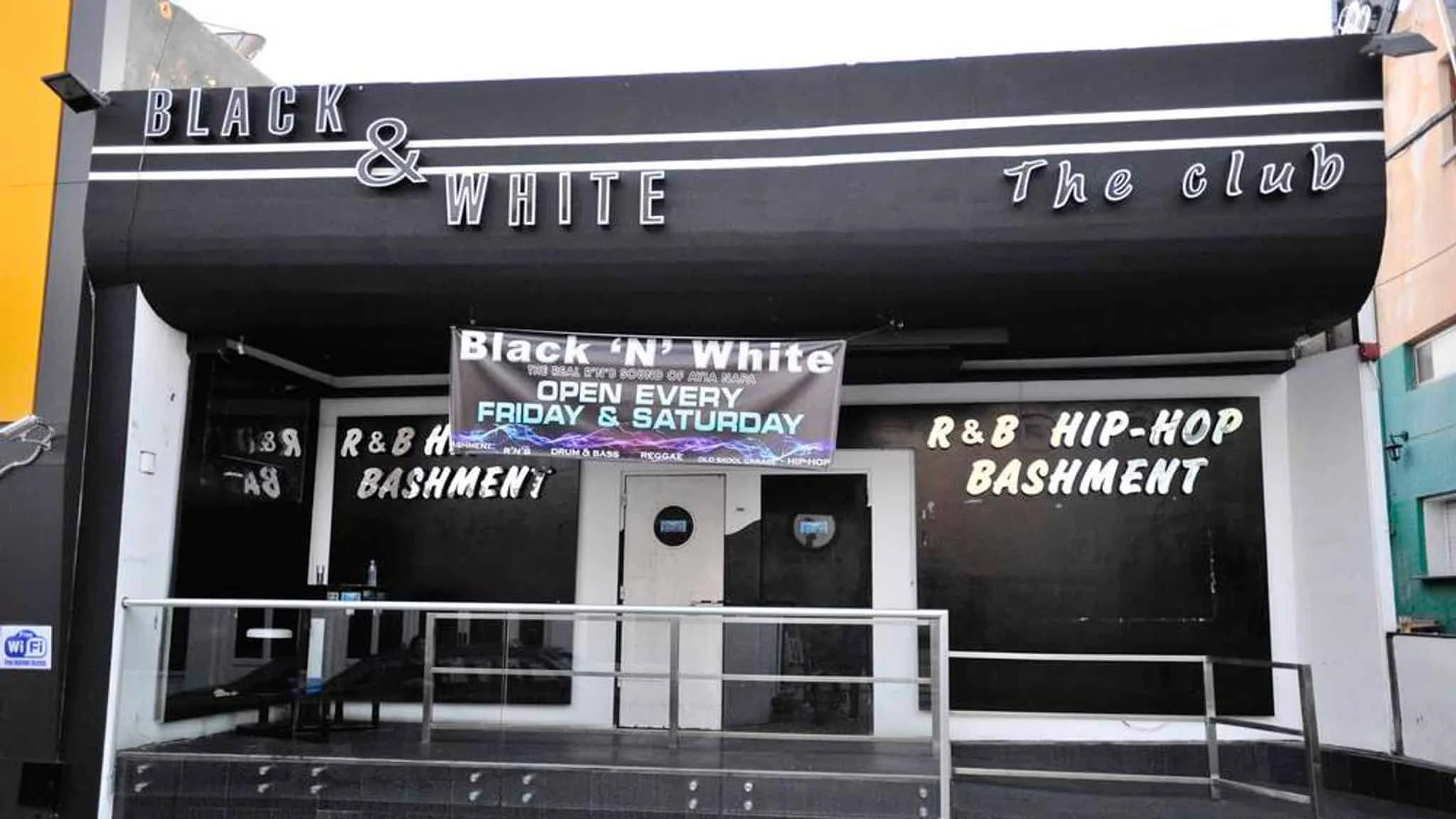 Black & White Club in Ayia Napa, featuring bold signage and a banner for R&B, hip-hop, and bashment nights on Fridays and Saturdays.