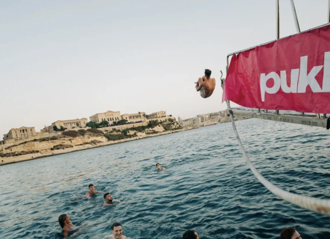 PUKKA UP Boat Party Malta man jumping of the side of the boat into the sea