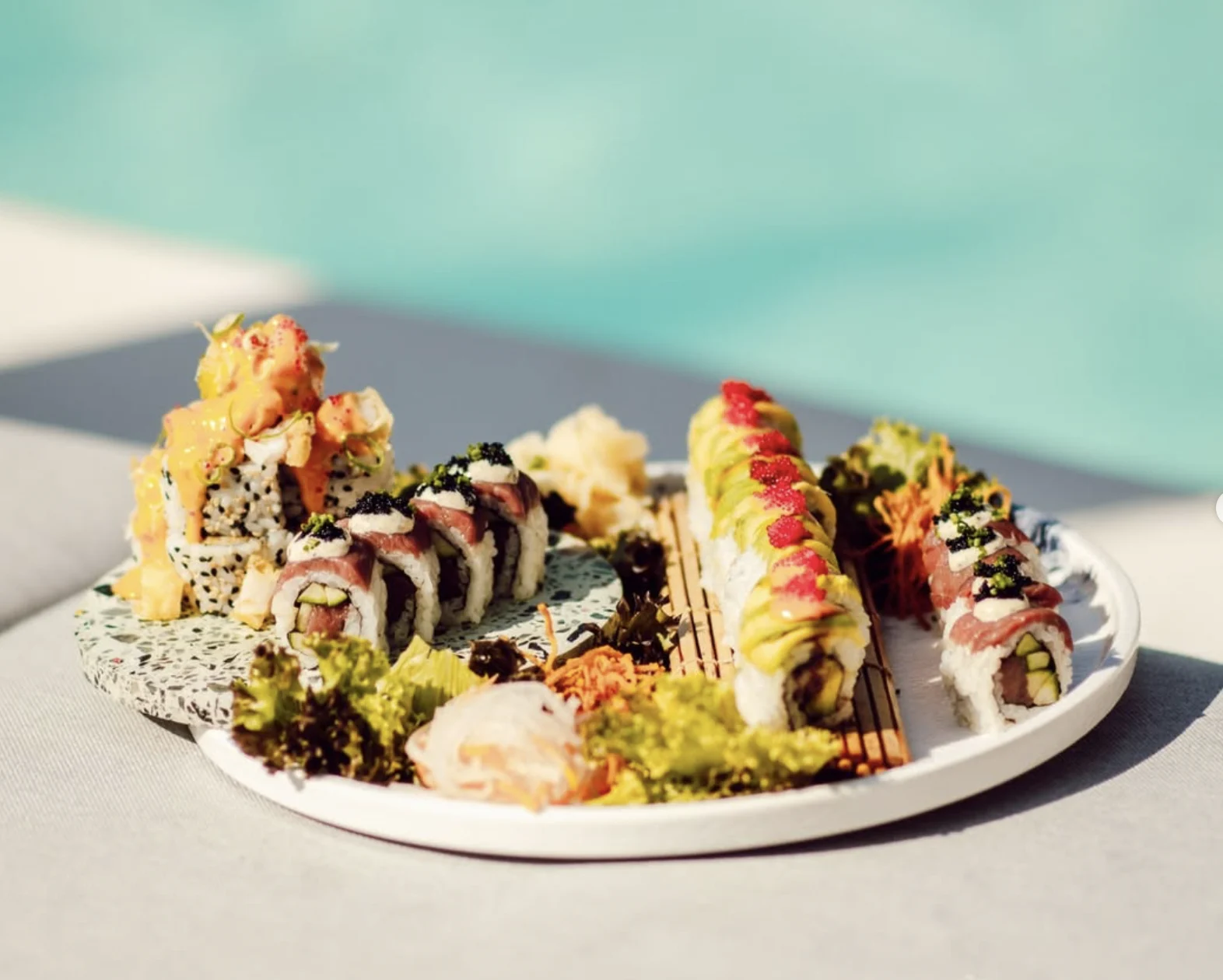 Omaka Restaurant Malta sushi on a plate by the poolside