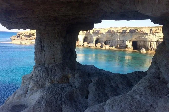 Stunning view of Sea Caves in Ayia Napa, with turquoise waters framed by rocky cliffs and natural arches.