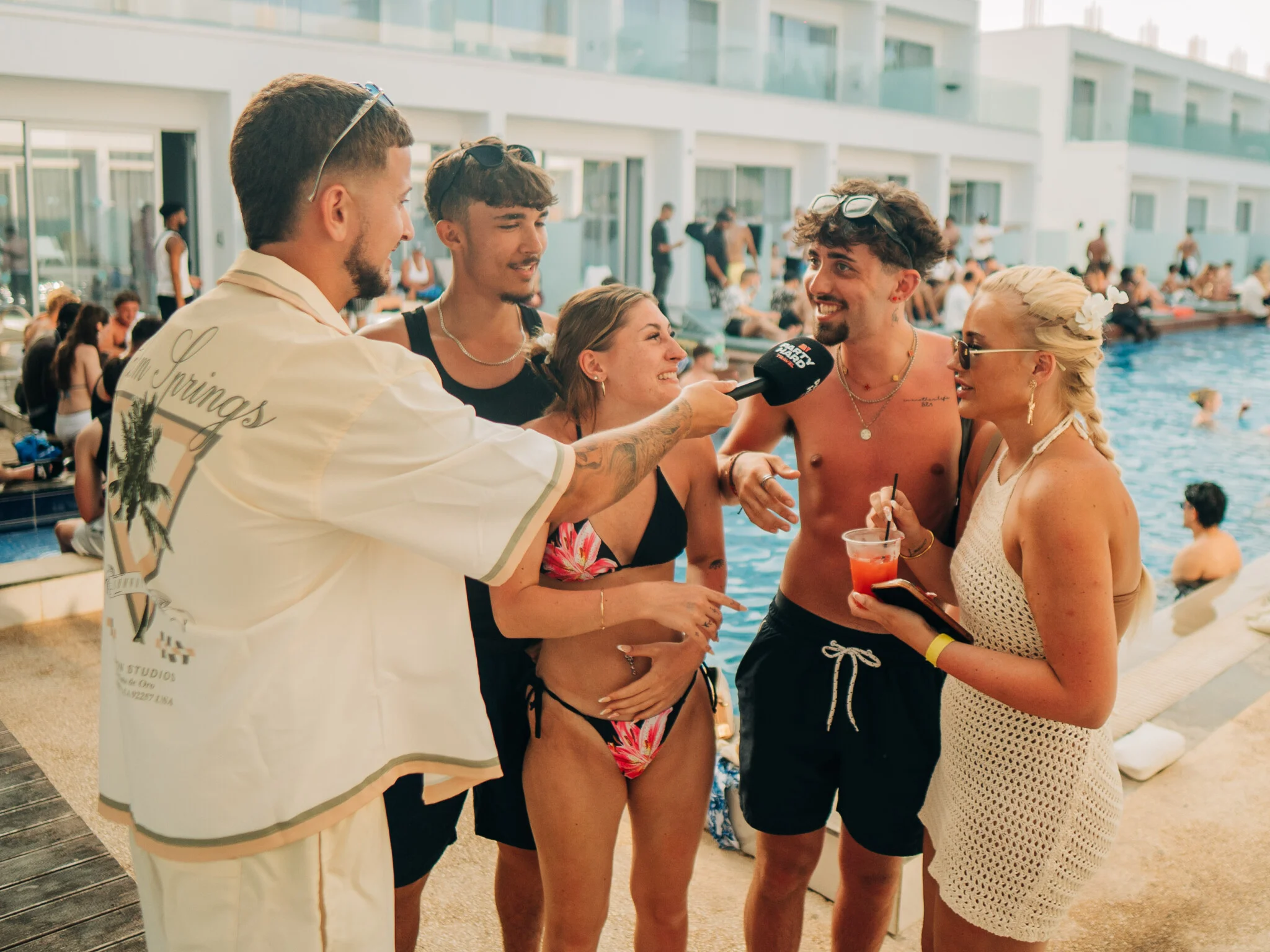 Andreas interviewing guests at sunset sessions pool party in ayia napa