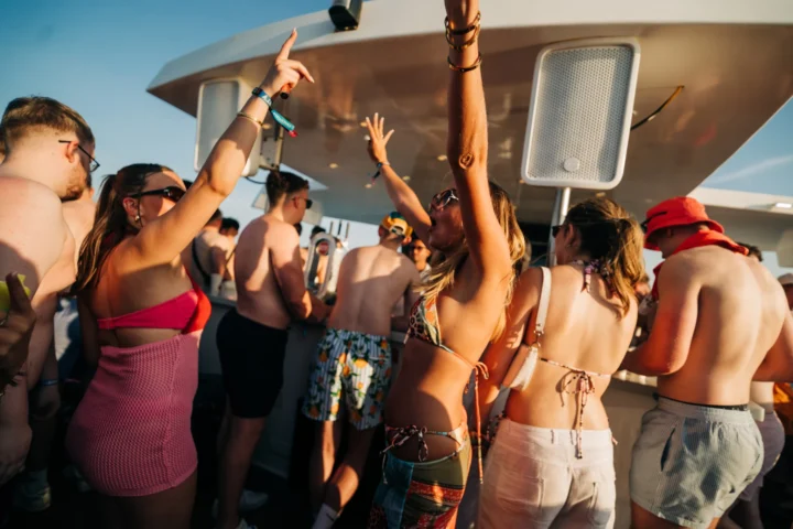 Girls and lads dancing and celebrating on deck at the Albufeira Boat Party, with music, drinks, and summer sunshine on the Algarve coast.