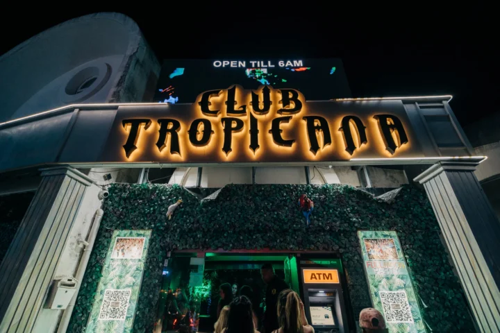 Entrance of Club Tropicana Albufeira glowing at night as partygoers head inside for another huge summer night out.