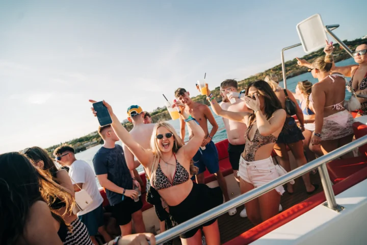 Girls and lads partying with drinks on the Albufeira Boat Party in Albufeira.