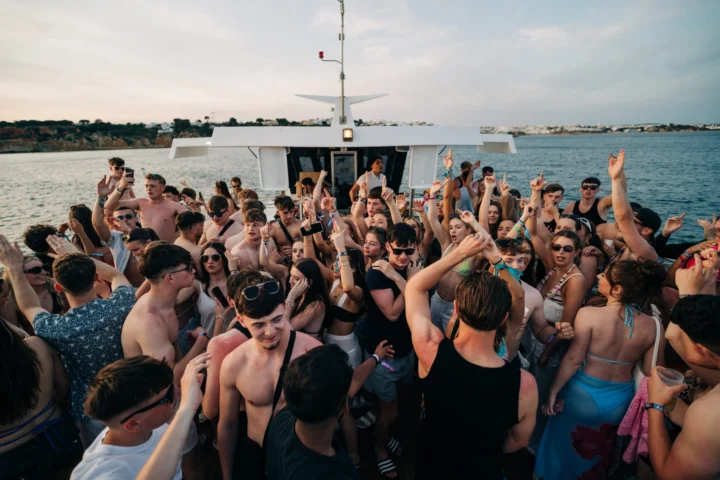 Lads and girls dancing on deck at the Albufeira Boat Party in Albufeira.