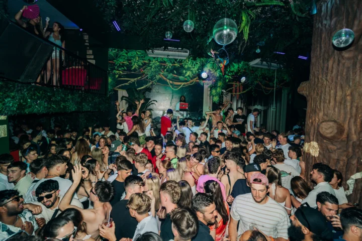 Club Tropicana Albufeira buzzing with party energy as the crowd dances under jungle lights and disco balls all night.