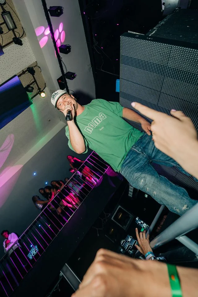 Performer hypes up the crowd at Club Heaven Albufeira, lights flashing and the party in full swing all night.