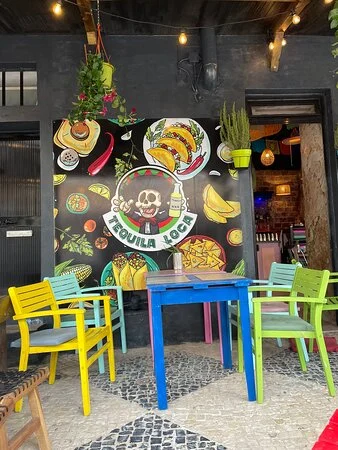 Colourful outdoor seating at Tequila Loca, a Mexican-themed bar on Albufeira’s Strip, with vibrant decor and a lively atmosphere.