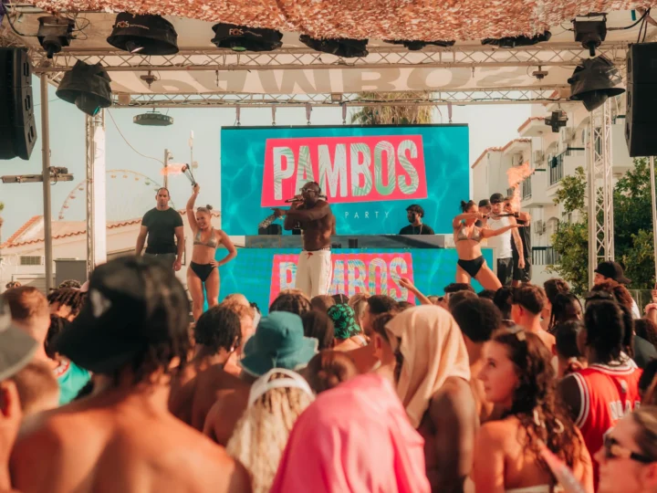 Crowds enjoying Pambos Pool Party in Ayia Napa with live performers, DJs and dancers on stage in the sun